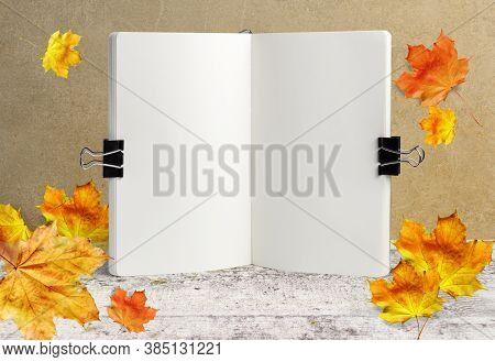 Notebook Mockup On Wooden Background With Autumn Leaves