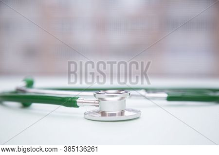 Stethophonendoscope On A Green Background.concept Of Medical Services And Insurance Of Medical Servi
