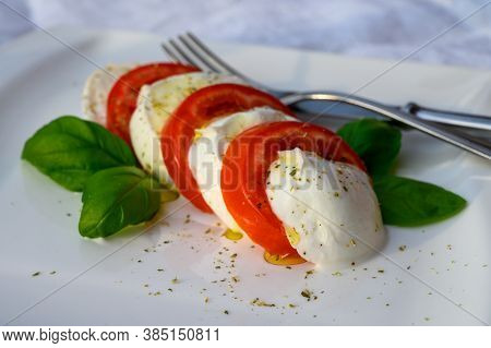 Caprese Salad Made With Fresh Soft White Italian Cheese Mozzarella Buffalo, Green Basil, Red Tomatoe