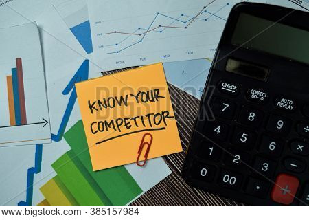 Know Your Competitor Write On Sticky Notes With Graphs And Diagram Isolated On Office Desk.