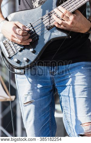Close-up Of A Man Musician Playing The Electric Guitar