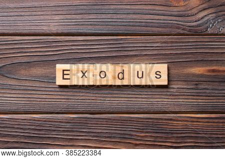 Exodus Word Written On Wood Block. Exodus Text On Table, Concept