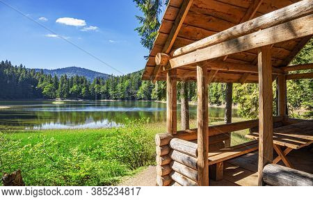 Wooden Log House On The Shore Of A Picturesque Lake.
