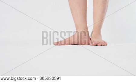 Male Legs And Barefoot Is Isolated On White Background.