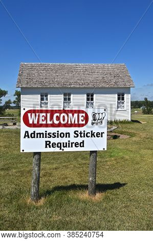 De Smet, South Dakota, August 5, 2020: The Admission Sticker Sign And Schoolhouse Building Are Found