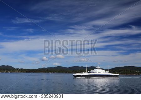 Norway Fiord Ferry Crossing. Passenger And Car Ferry Vessel Across Bjornafjord In Midhordland Region