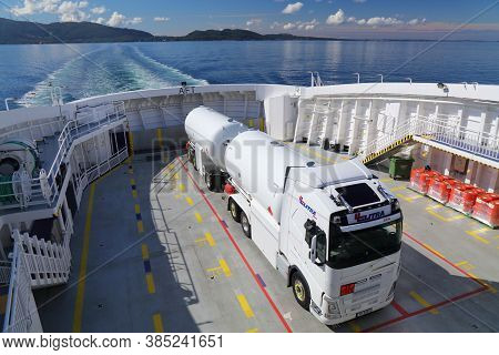 Bjornafjord, Norway - July 23, 2020: Tanker Truck Transported On A Car Ferry Crosses Bjornafjord In 