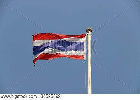 National Flag Of Thailand On Bright Blue Sky Background. Blown Away By Wind. Thailand Is One Of The 