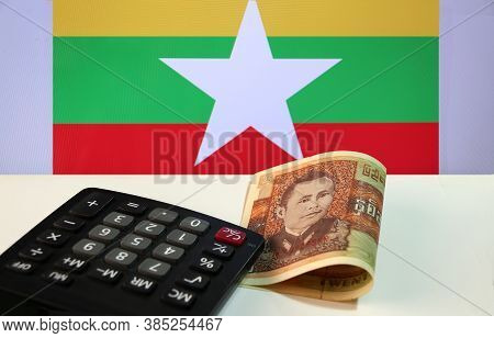 Twenty-five Of Banknote Currency Myanmar Kyats With Calculator On The White Floor With The Union Of 