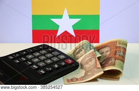 Pile Of Banknote Currency Myanmar Kyats With Calculator On The White Floor With The Union Of Myanmar