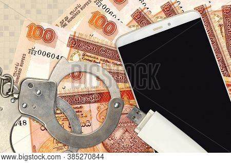 100 Sri Lankan Rupees Bills And Smartphone With Police Handcuffs. Concept Of Hackers Phishing Attack