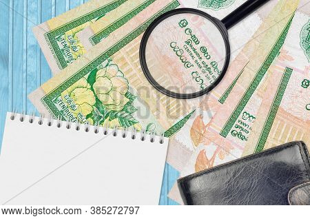 10 Sri Lankan Rupees Bills And Magnifying Glass With Black Purse And Notepad. Concept Of Counterfeit