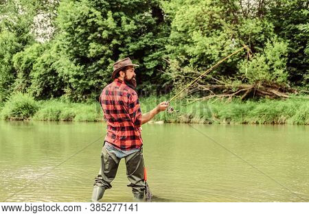 Keep Calm And Fish On. Mature Man Fly Fishing. Man Catching Fish. Fisherman With Fishing Rod. Hobby 