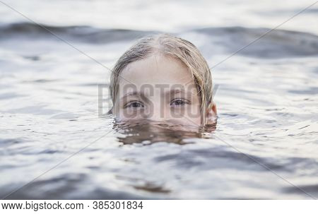 Teenager Girl Bathes In A River And Only Half Of Her Face Is Visible