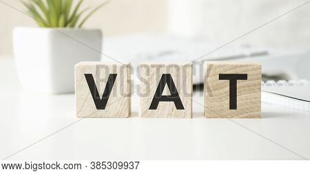 Vat On Wooden Cubes Over Blur Background With Copy Spcae, Financial Concept Background