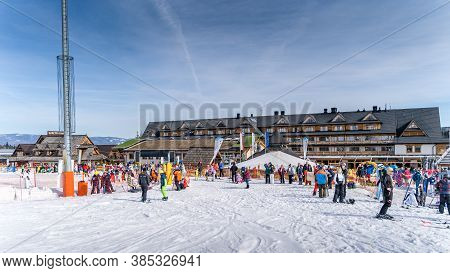 Bialka Tatrzanska, Poland, March 2019 Groups Of Skiers, Kids And Adults Learning How To Ski With Ins