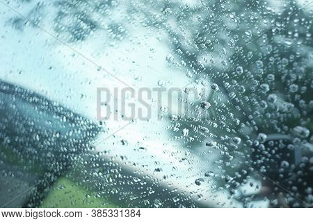 Blurred Many Rain Drops On The Car Window With Blue Tone Condition Background In Rainy Day