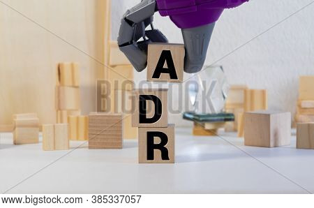 Letter Block In Word Adr On Wood Background.