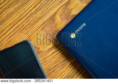 Blue Asus Chromebook And Iphone On A Wooden Table, Top View. Bishkek, Kyrgyzstan - June 8, 2019.