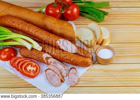 Polish Kielbasa With Vegetables And Bread On Wooden Background. Top View.