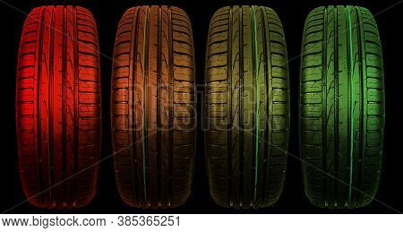 Car Tire Isolated On Black Background In Red And Green Tones. Tire Stack. Car Tyre Protector Close U