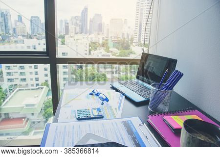 Office Laptop Business Financial Document Chart And Graph On Wooden Table With Coffee Cup. Flat Lay 