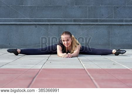 Stretching Gymnast Woman Doing Split, Twine In Workout Sports Ground
