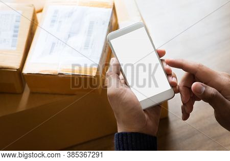 Online Shopping Concepts With Youngman Using Smartphone On Product Package Box.ecommerce Market.tran