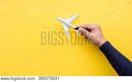 Business Transportation Or Aviation With Male Hand Holding Mockup Airplane.go To Travel After Covid 