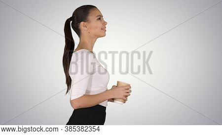 Relaxed Stylish Businesswoman Drinking Coffee Walking On Gradien