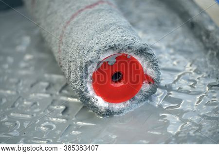 Fibers Of A Paint Roller In A Tray With Gray Paint, Close-up
