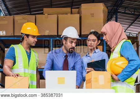 Group Of Diversity Warehouse Worker Meeting And Brainstorming Together In Local Warehouse, Muslim Wi