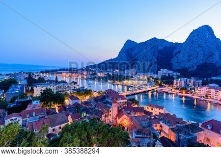 View Omis Town At Sunset With Illuminated And Reflection. Croatia.