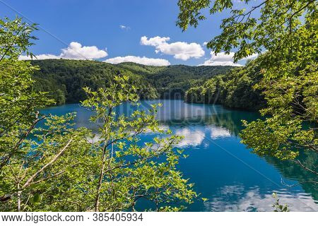 Lake Galovac Landscape. Tree Branches In The Foreground. Sunny Day. Croatia, Europe.