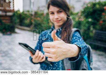 Schoolgirl Shows Thumbs Up, She Is Happy And Goes Back To School