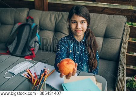 Healthy School Breakfast, Peach In The Hands Of A Schoolgirl