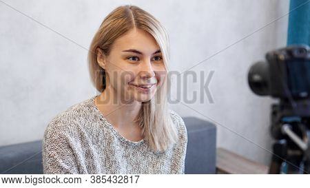 Young And Smart. Beautiful Young Woman In Casual Wear While Recording Video Blod