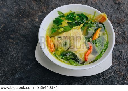 Gurame Fish Head Soup Or Sup Kepala Ikan Gurame With Basil Leaves, Tomatoes, Yellow Curry, And Chill