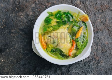 Gurame Fish Head Soup Or Sup Kepala Ikan Gurame With Basil Leaves, Tomatoes, Yellow Curry, And Chill