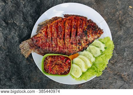 Delicious Grilled Tilapia (nila Bakar) From Indonesia With Rice, Tempeh, Vegetables, And Chilli Sauc