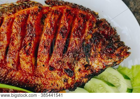 Delicious Grilled Tilapia (nila Bakar) From Indonesia With Rice, Tempeh, Vegetables, And Chilli Sauc