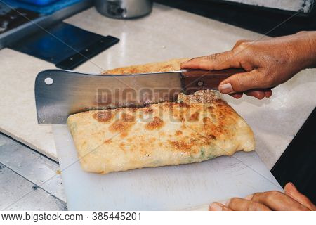 Martabak Telor Or Omelette Martabak. Savoury Pan-fried Pastry Stuffed With Egg, Meat And Spices. Tra