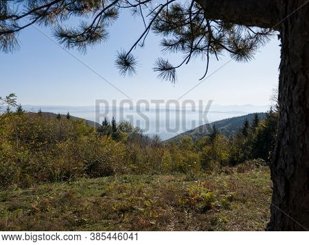 Scenic View From The Mountain Kozara On The Fog-filled Valley During A Sunny Day.