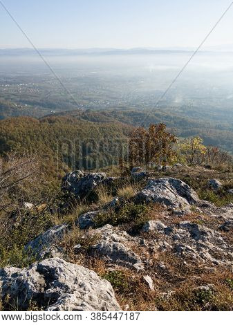 Scenic View From Kozara Mountain To The Valley Filled With Fog And Smoke During A Sunny Day.