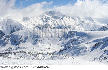 Ariel View Of Snowy Mountains And Blue Sky In Bansko Resort, Bulgaria. Majestic High Mountains Peaks