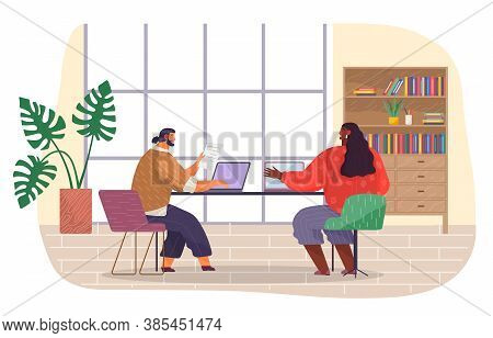 Office Staff, Wokrplace. Bearded Man With Fashionable Haircut Sits On Chair At Table, Works At Lapto