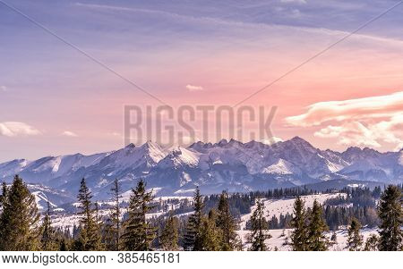 Sunset With Dramatic Sky And Panoramic View On Forest And Snowy Tatra Mountains In Winter Time. Ski 