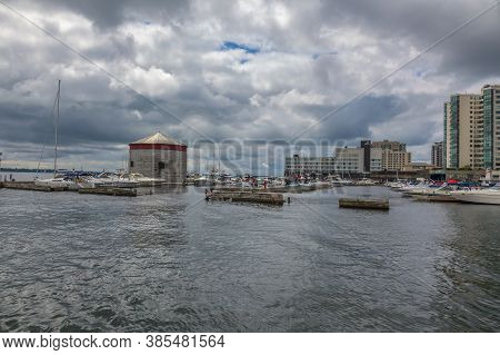 Kingston, Ontario, Canada, August 2014 - The Marina And Historic Stone Martello Tower At The Waterfr