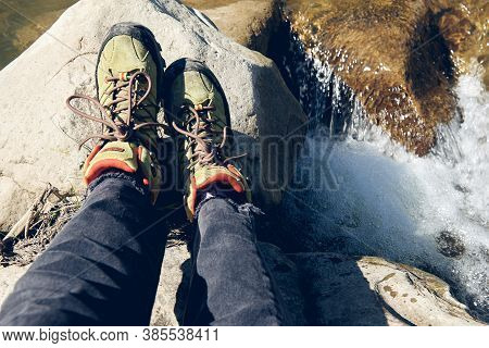 Hiking Boots In Outdoor Action. Top View Of Boot On The Trail. Close-up Legs In Jeans And Sport Trek