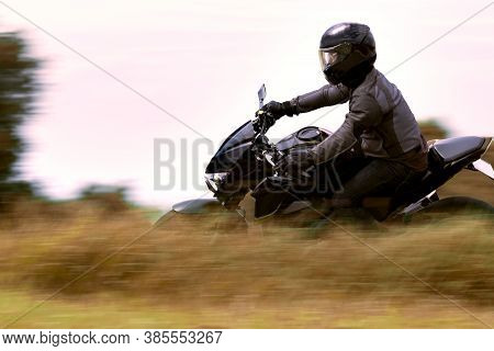 Man Riding Sport Motorcycle Leaning On Curve Road